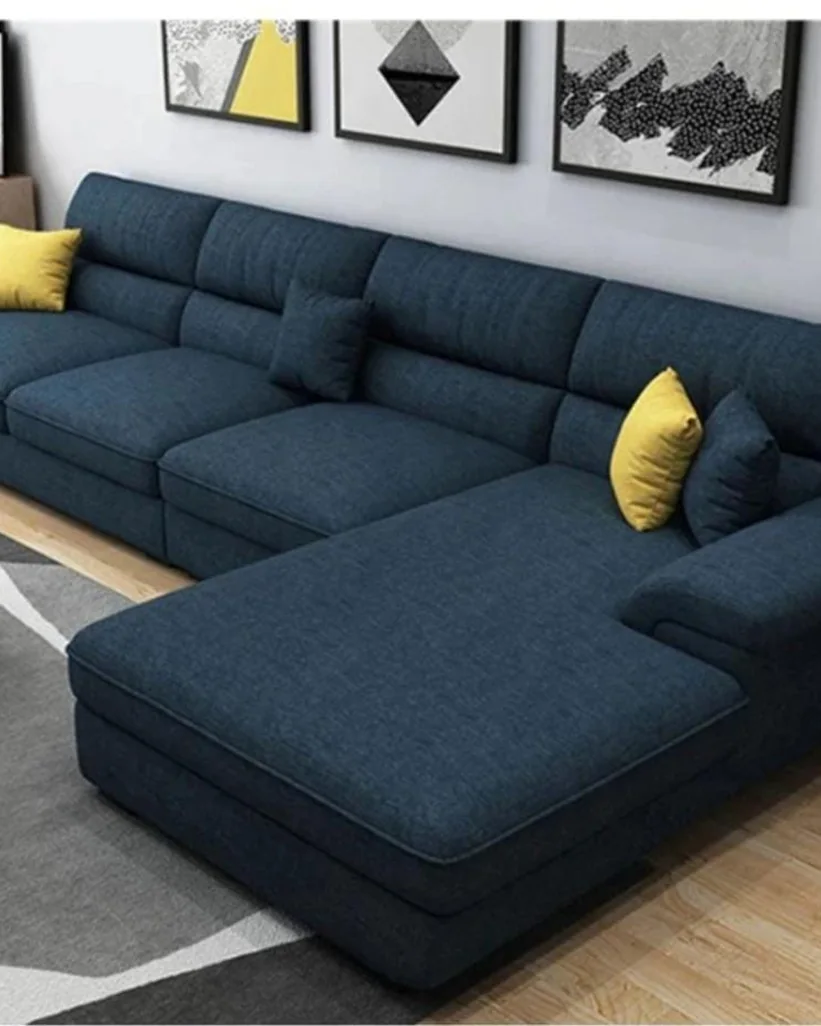 Navy blue L-shape sofa with a long chaise in a modern living room.