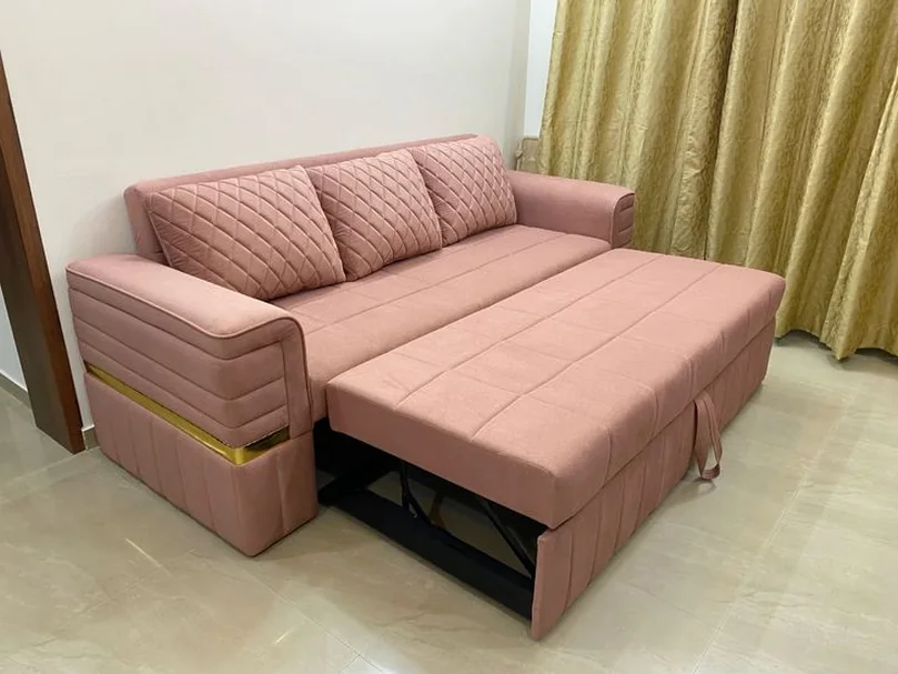 Blush pink sofa-cum-bed pulled out flat.