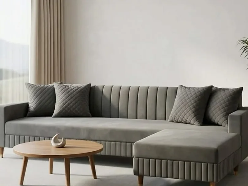 Grey channel-tufted L-shape sofa on tapered legs.