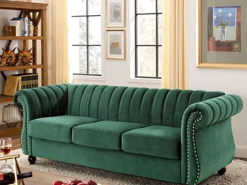 Green velvet chesterfield with stud detailing.
