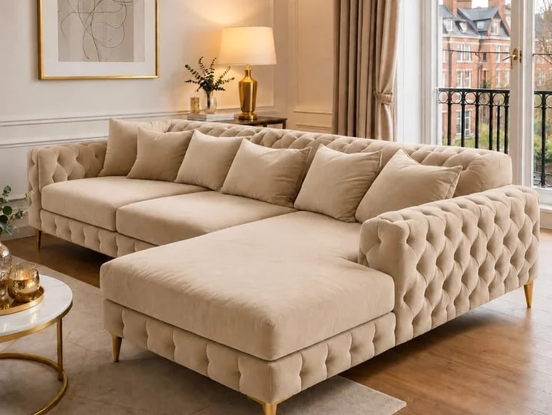 Cream buttoned chesterfield L-shape sofa with a deep chaise.